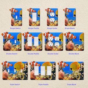 May include: A set of 12 decorative wall plates featuring a colorful underwater scene with clownfish and angelfish. The plates are designed to fit over standard light switches and outlets. The plates are available in single, double, and triple switch and outlet configurations.