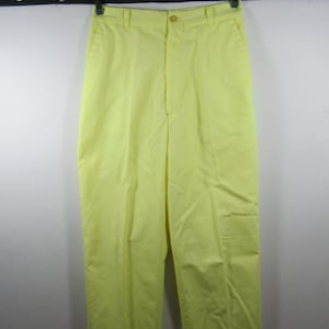 May include: A pair of yellow high-waisted pants with a button and zipper closure.