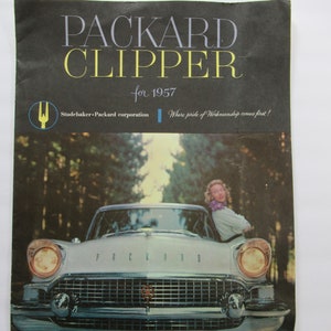 May include: A vintage black and white brochure for the Packard Clipper car for 1957. The brochure features a photo of the car's front end and the text "PACKARD CLIPPER for 1957" and "Studebaker-Packard corporation" and "Where pride of Workmanship comes first!"