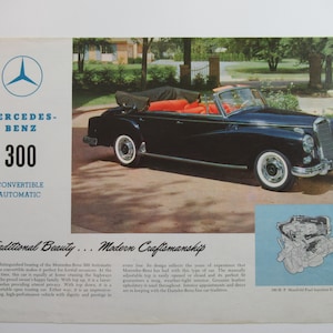 May include: A black Mercedes-Benz 300 convertible with a red interior, parked on a paved driveway. The car has a whitewall tire and a chrome bumper. The text "Mercedes-Benz 300 Convertible Automatic" is printed on the left side of the image. The text "Traditional Beauty... Modern Craftsmanship" is printed below the car. The text "180 H.P.  Mansfield Fuel Injection Engine" is printed below a diagram of the engine.