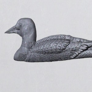 May include: A gray, detailed, ceramic sculpture of a loon, a type of diving bird, with a long, slender body and a pointed beak.