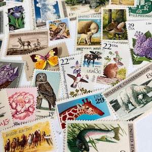 May include: A collection of vintage U.S. postage stamps featuring wildlife, flowers, and historical themes. Stamps depict a variety of animals, including a giraffe, owl, and bear, along with images of horses, flowers, and landscapes. The stamps are in various colors and sizes.