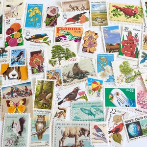May include: A collection of colorful vintage postage stamps featuring various wildlife, flowers, and landscapes. The stamps showcase images of birds, animals, and scenic views, with denominations like 3c, 8c, 15c, 22c, 25c, 29c, and 32c.