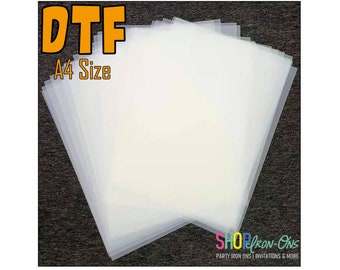 May include: A stack of clear A4 size DTF transfer sheets. The sheets are translucent and have a smooth surface. The text "DTF A4 Size" is printed in orange on a black background.