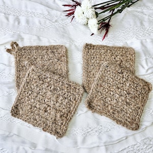 May include: Four brown crocheted pot holders made from natural jute fiber. The pot holders are square shaped and have a textured surface.