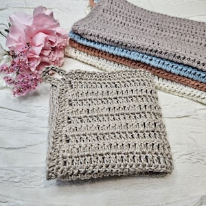 May include: A set of four crocheted dishcloths in various shades of brown, blue, and white. The dishcloths are made with a textured, open weave pattern.