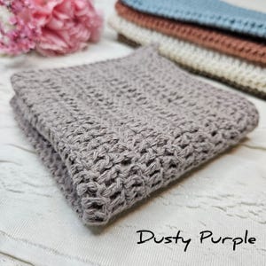 May include: A dusty purple knitted fabric backdrop for photography. The fabric is soft and textured, with a subtle sheen. It is perfect for adding a touch of elegance to your photos.