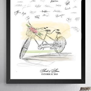 May include: A black framed print of a hand-drawn illustration of a tandem bicycle with a basket of flowers. The bicycle is on a light yellow background with a watercolor effect. The print includes the text "Sarah & Adam, October 31, 2019".