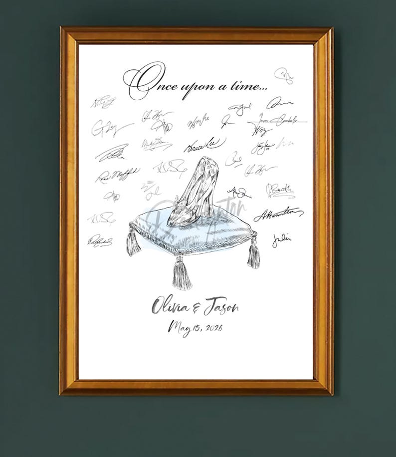 May include: A framed print featuring a Cinderella-style glass slipper on a blue pillow with tassels. The words "Once upon a time..." are at the top, with signatures and the names "Olivia & Jason" and the date "May 15, 2026" below.