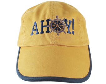 Ahoy! Nautical Boat Wheel Greeting Embroidery on a Polo Style 5 Panel Adjustable Mango and Navy Unstructured Cap for the Boating Enthusiast