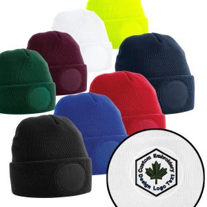 May include: A collection of ribbed knit beanies in various colors, including black, green, red, blue, white, and yellow. Each beanie features a circular patch, with a close-up of a patch with the text "Custom Design Logo Text" and a maple leaf.