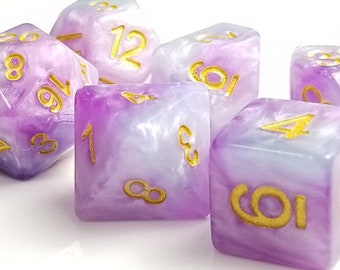 May include: Set of seven purple and white iridescent dice with gold numbers. The dice are a d4, d6, d8, d10, d%, d12, and d20.