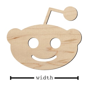 May include: A wooden cutout of the Reddit alien mascot, known as Snoo. The cutout is light brown and features a smiling face with two eyes and a small antenna on top of its head.