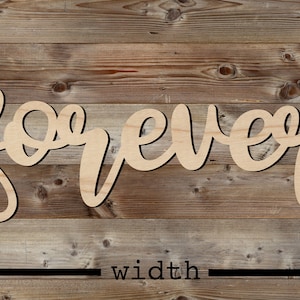 May include: Wooden cutout of the word "forever" in a cursive font. The cutout is on a woodgrain background with a black line measuring the width of the cutout.