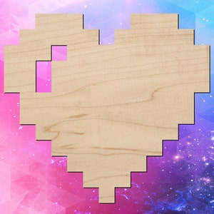 May include: A wooden heart-shaped cutout with a pixelated design. The heart is made of light brown wood and has a pink pixelated design in the center.
