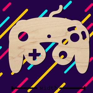 Può includere: Un ritaglio in legno di un controller per videogiochi a forma di un classico controller Nintendo 64. Il controller è di colore marrone chiaro e ha un contorno marrone scuro. Il controller è su uno sfondo viola con linee diagonali in giallo, rosa e blu.