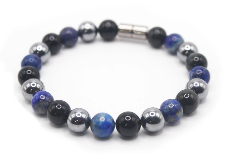 May include: A beaded bracelet with blue, black and silver beads. The bracelet has a magnetic clasp.