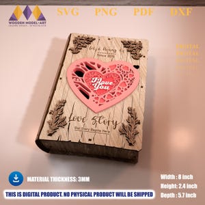 Peut inclure: Boîte en bois découpée au laser avec un motif de cœur rose. La boîte mesure 20.3 cm de large, 6.1 cm de haut et 14.5 cm de profondeur. Le texte sur la boîte est "Love Story" et "I Love You".