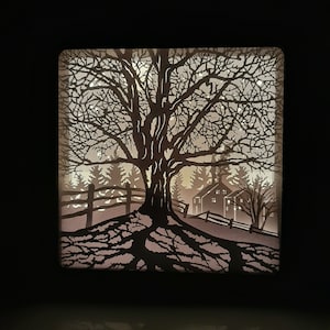 May include: A black silhouette of a tree with intricate branches and roots, set against a white background. The tree is in front of a small house with windows and a fence. The image is reminiscent of a winter scene.
