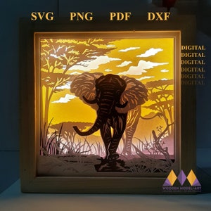 May include: A digital download of a silhouette design for a wooden shadow box featuring an elephant walking through a savanna landscape. The design is available in SVG, PNG, PDF, and DXF formats.