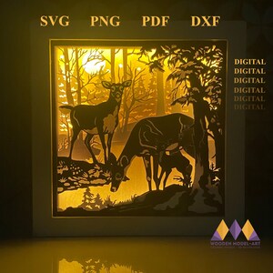 Peut inclure: Un fichier de découpe numérique représentant deux cerfs dans un décor de forêt. Le design est parfait pour créer un effet 3D en couches avec une source de lumière derrière. Le fichier est disponible aux formats SVG, PNG, PDF et DXF.