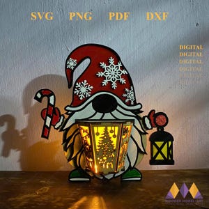 May include: A red and white Christmas gnome holding a candy cane and a lantern. The gnome has a white beard and a red hat with snowflakes. The lantern has a yellow light inside and a Christmas tree design.