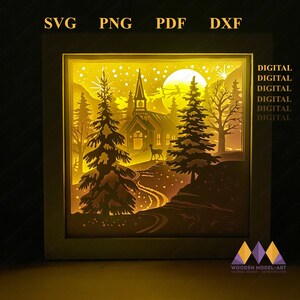 May include: A digital download of a 3D layered papercraft design featuring a snowy winter scene with a church, trees, and a deer. The design is perfect for creating a unique and festive holiday decoration.