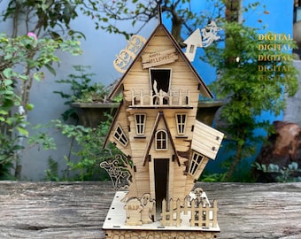 Può includere: Una casa infestata in legno a tema Halloween con intricati dettagli tagliati al laser. La casa presenta un design storto, finestre, una porta d'ingresso e un cartello con la scritta "Happy Halloween". Sono inclusi anche una recinzione, una lapide e uno scheletro.