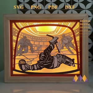 May include: A digital file for a laser cut hockey player in a goal scene. The file includes a hockey player in the goal, a goalie, and two other players. The scene is lit from behind, creating a shadow effect.