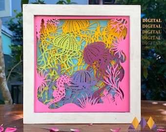 May include: A framed digital cut file design featuring a seahorse and jellyfish in a pink, yellow, purple, and green color scheme. The design is perfect for creating a decorative wall hanging or a unique home decor piece.