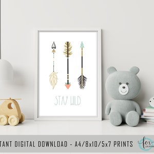 May include: A printable art print with three stylized arrows in gold, black, and teal with feathers and geometric patterns. The text "Stay Wild" is printed below the arrows in a light blue font.