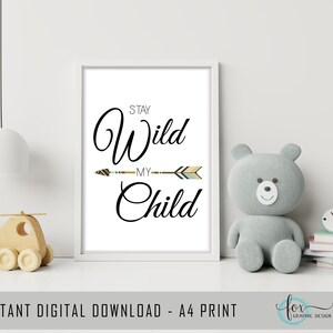May include: A white printable poster with the text "Stay Wild My Child" in black cursive font. A colorful arrow with a brown, white, and blue pattern is centered above the word "My".