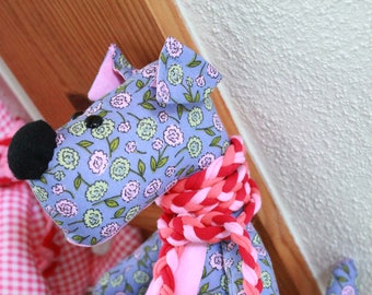 Purple stuffed dog with flowers
