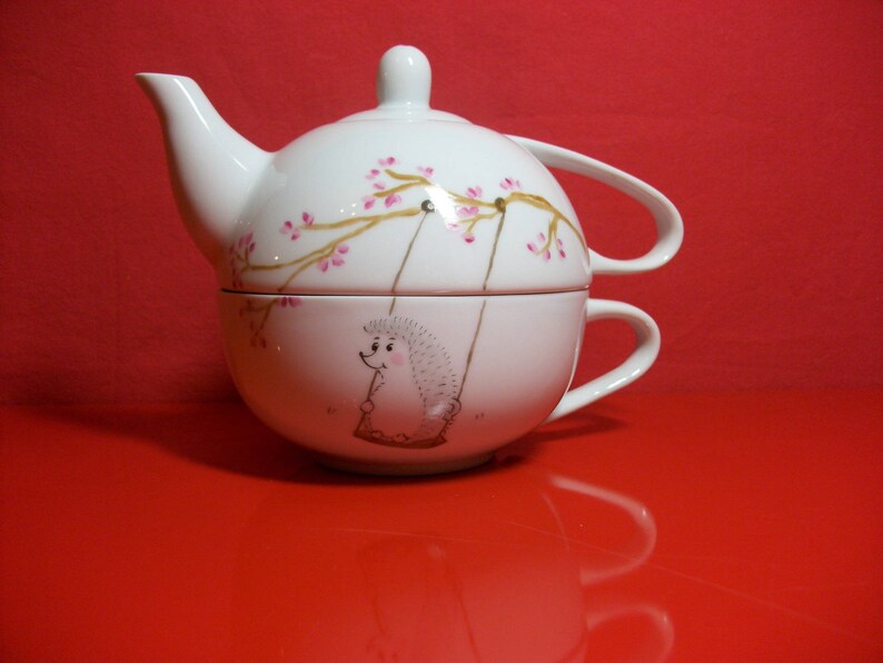 Selfish called teapot in Limoges porcelain decorated by hand with a Hedgehog on a swing