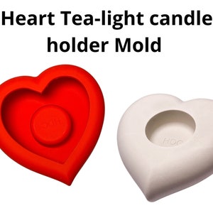 May include: A red silicone heart-shaped mold for making tea light candles. The mold has a smaller heart-shaped cutout in the center for the candle.