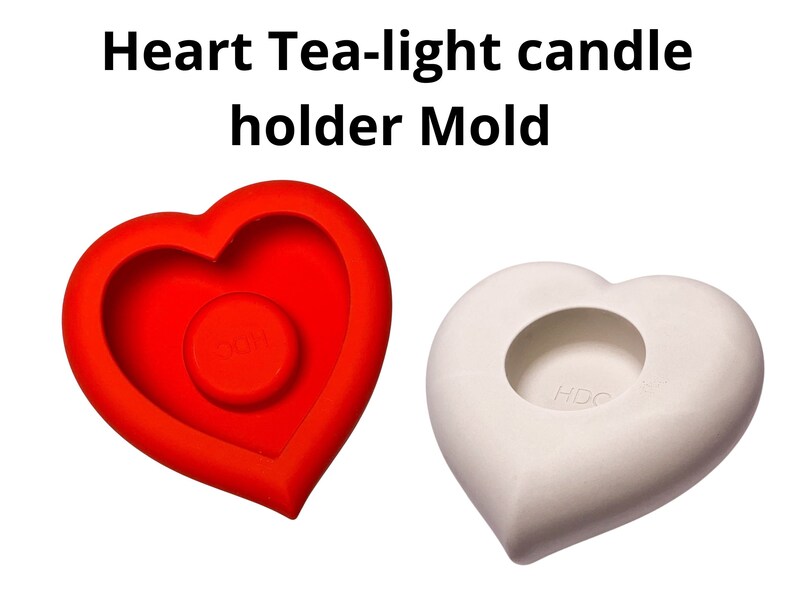 May include: A red silicone heart-shaped mold for making tea light candles. The mold has a smaller heart-shaped cutout in the center for the candle.