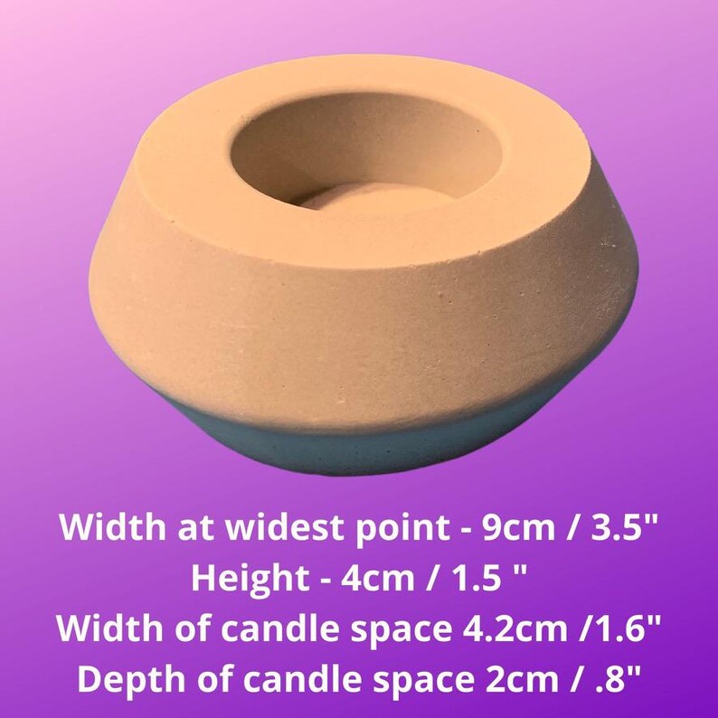 May include: A light brown concrete candle holder with a round opening for a candle. The holder is 3.5 inches wide and 1.5 inches tall. The candle space is 1.6 inches wide and .8 inches deep.