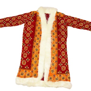 May include: A long red and orange robe with a white fur trim. The robe has a floral pattern and is open in the front.