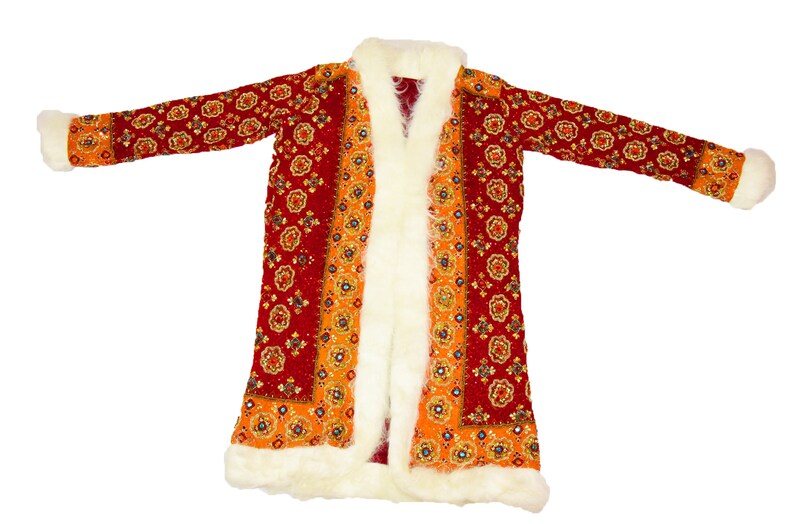 May include: A long red and orange robe with a white fur trim. The robe has a floral pattern and is open in the front.