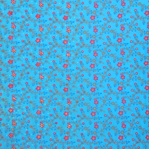 May include: A blue fabric with a floral pattern embroidered in pink, gold, and silver thread. The fabric has a gold and silver border.