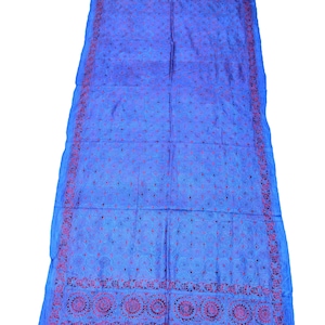 May include: A blue silk shawl with intricate red embroidery. The shawl features a repeating pattern of circles and floral motifs.