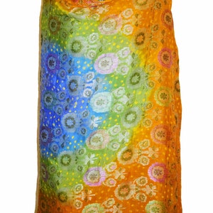 May include: A colorful shawl with a rainbow ombre pattern and floral designs. The shawl is made of a soft, lightweight fabric and is perfect for adding a touch of color to any outfit.