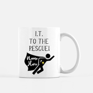 May include: White ceramic mug with the text "I.T. TO THE RESCUE!" and a superhero graphic. The superhero graphic includes a black silhouette with a cape and a star. The words "Name Here" are on the cape.