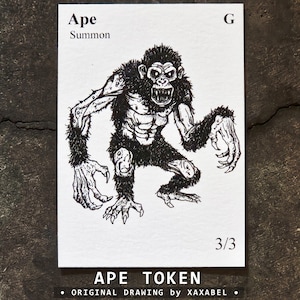 May include: A white rectangular game card featuring a black ink illustration of a muscular ape with bared teeth. The text at the top reads Ape, Summon, and G. The bottom right corner displays 3/3. The card is labeled Ape Token and Xaxabel.