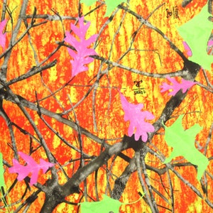May include: A colourful camouflage design with orange, yellow, and red tones. The pattern includes dark branches, bright pink oak leaves, and neon green leaves. The text "True Timber Sassy B" is visible.
