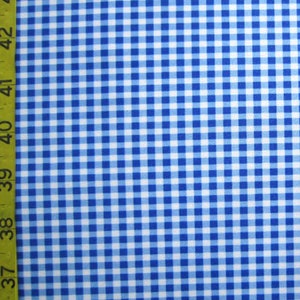 May include: Blue and white gingham fabric with a yellow measuring tape along the left side. The fabric is a classic checkered pattern, with evenly spaced squares of light and dark blue. The measuring tape shows inch measurements.