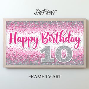 May include: A rectangular digital art display in a light wood frame featuring a pink and silver glitter background. The text reads Happy Birthday in pink script and the number 10 in large silver glitter digits with a white outline.