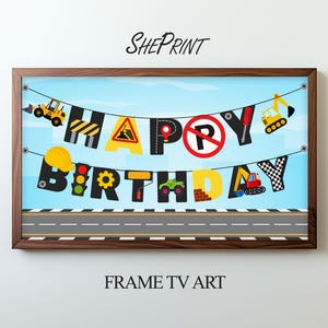 May include: A framed print with a construction theme. The words "HAPPY BIRTHDAY" are spelled out with construction-themed images and letters. The print includes a road design at the bottom and the text "SHEPRINT" and "FRAME TV ART".
