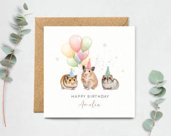 May include: A birthday card with three hamsters wearing party hats and surrounded by colorful balloons. The card says "Happy Birthday Amelia".