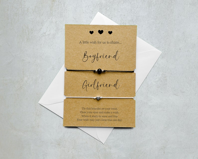 May include: Two friendship bracelets on a brown card with the words "Boyfriend" and "Girlfriend" printed on them. The card also includes the text "A little wish for us to share... The this bracelet on your wrist, Close your eyes and make a wish. When it starts to wear and fray Your wish may just come true one day."